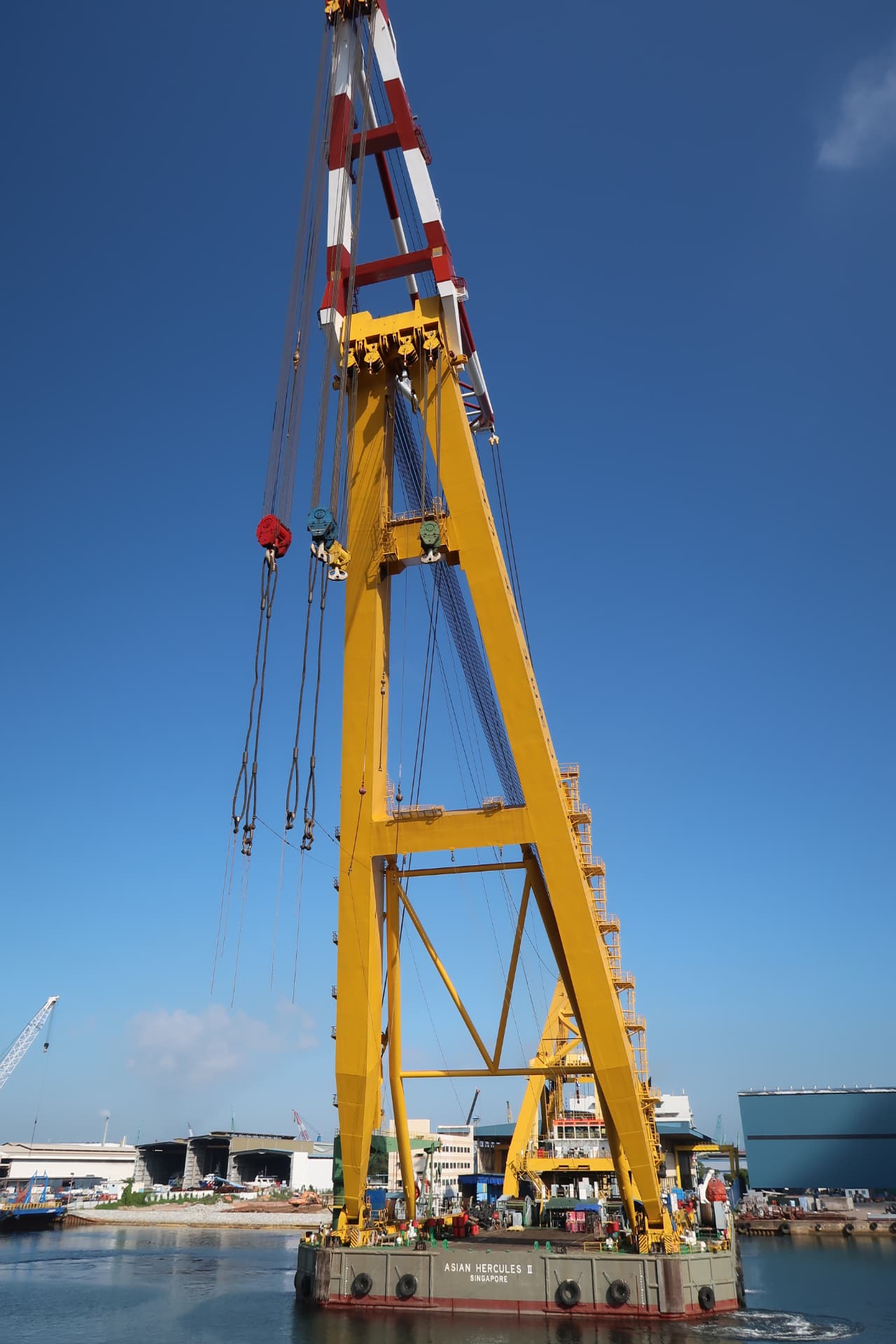 Asian Hercules heavy-lift sheerleg barge in harbour, hook clear