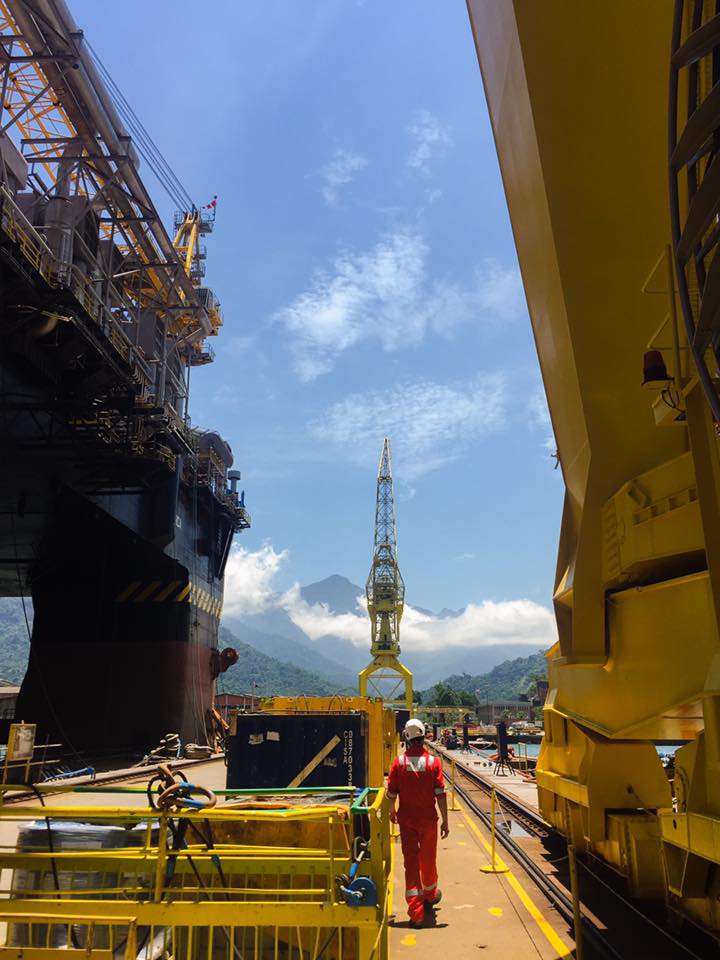 Engineer walking the quay between a vessel and a heavy structure